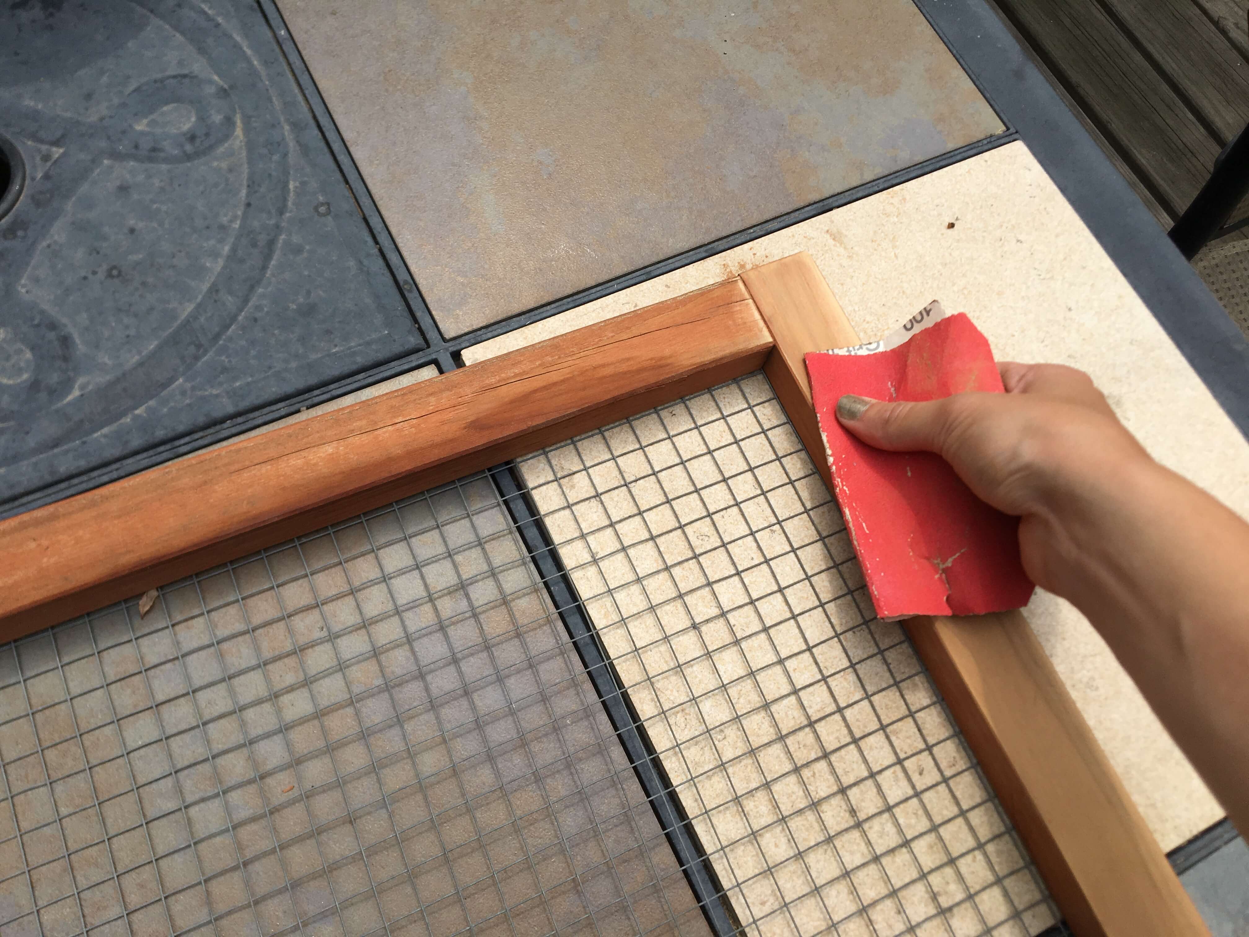 Sanding the frame of the coop piece