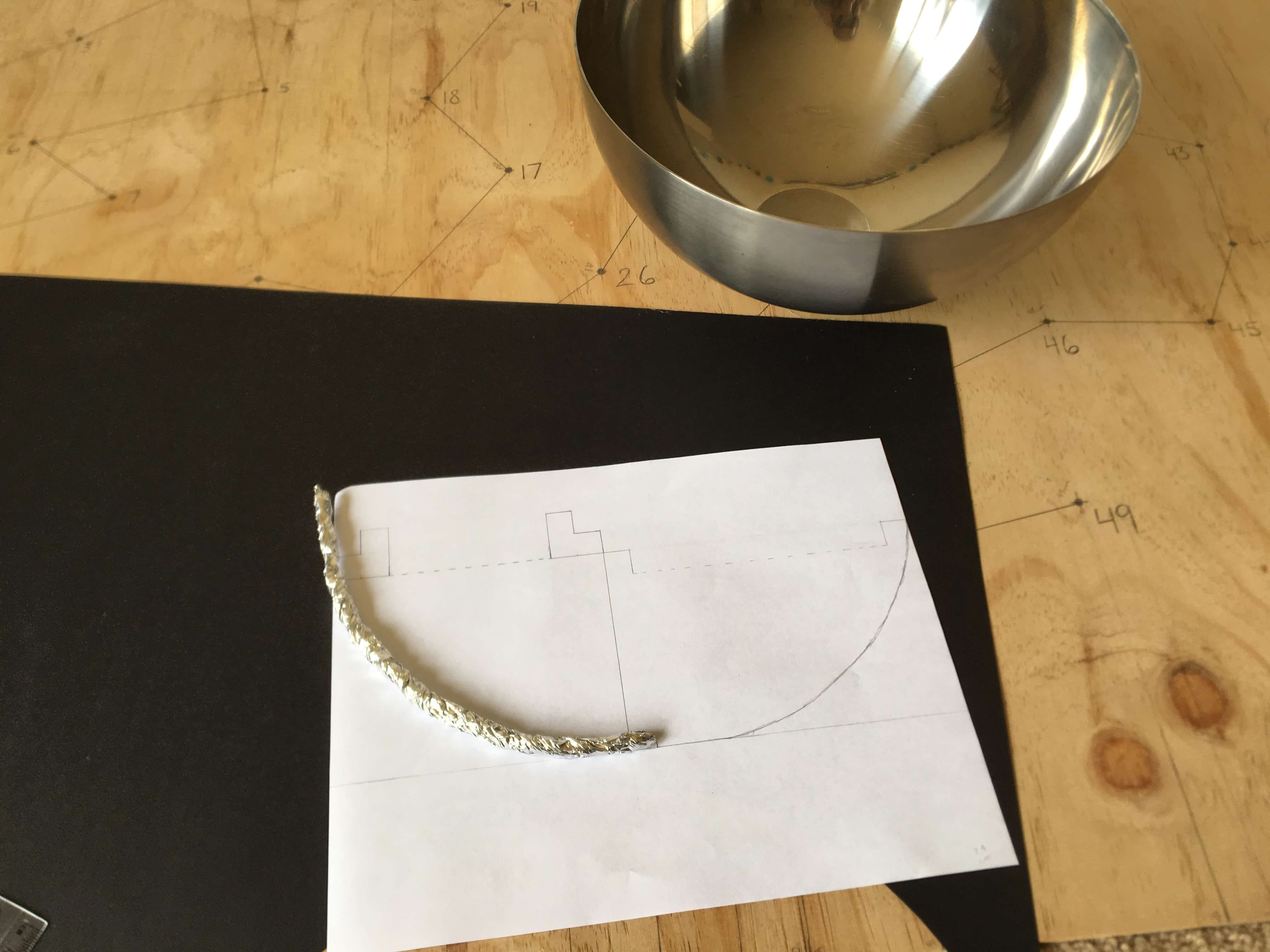 using tin foil to trace the curve of the bowl